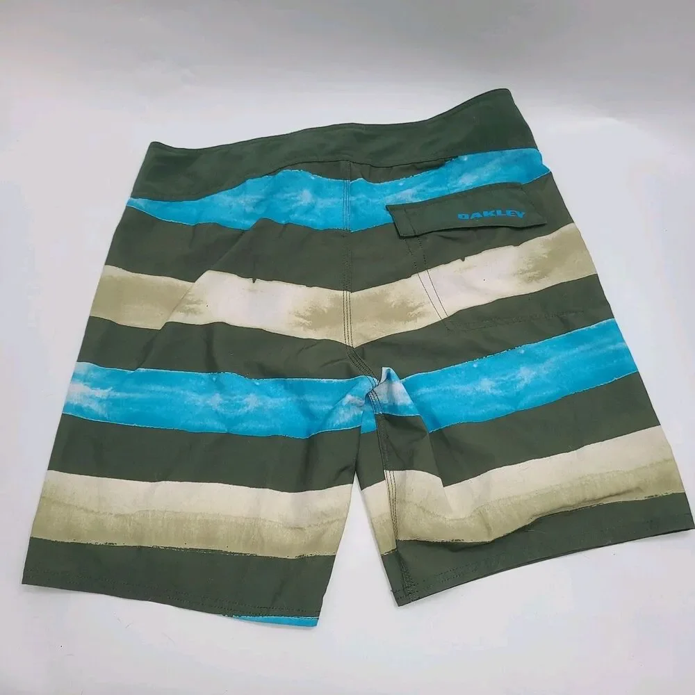 Oakley Crashing Wave board shorts with a multi-color stripe pattern. Men's 34